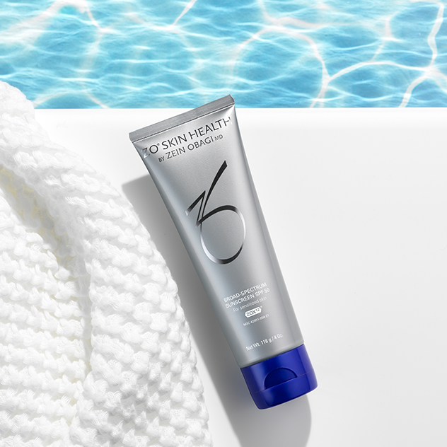 Broad Spectrum Sunscreen beside a pool