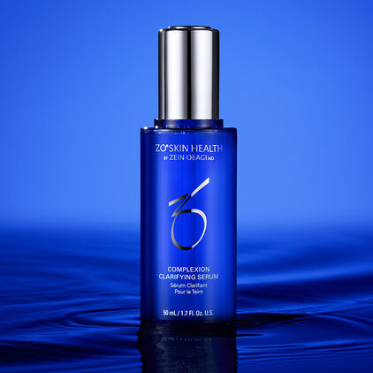 Complexion Clarifying Serum on top of a water, on a blue background