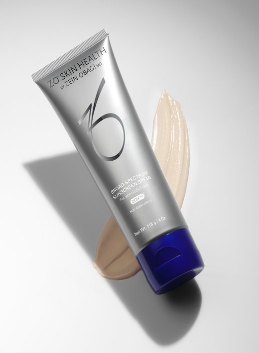 Broad Spectrum Sunscreen on gray background with a cream swatch image number 2