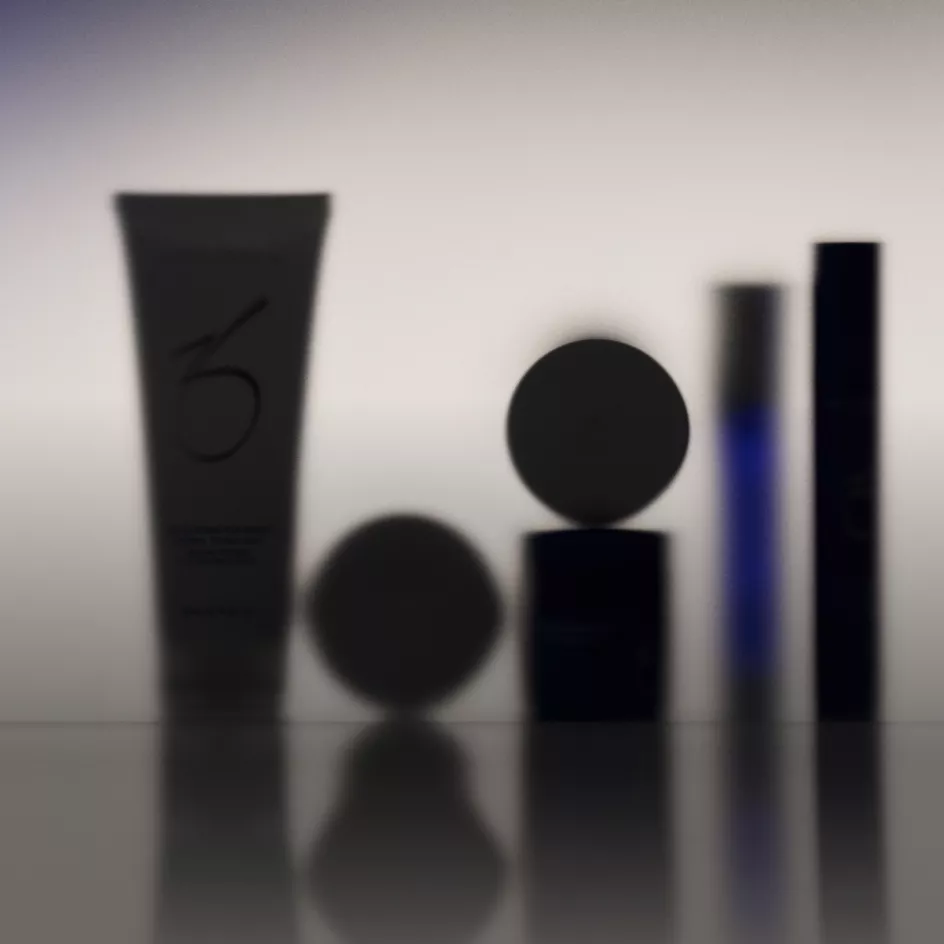 Luxury beauty products arranged with metallic accessories